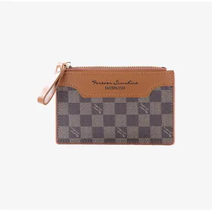 Close-up of dual-texture card holder with zipper and checkerboard pattern details
