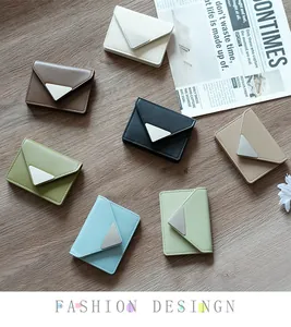 Flat lay of envelope wallets in seven trendy colors on a rustic wooden background