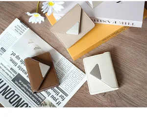 Three envelope-style PU leather card holders in brown, beige, and cream with metal buckles