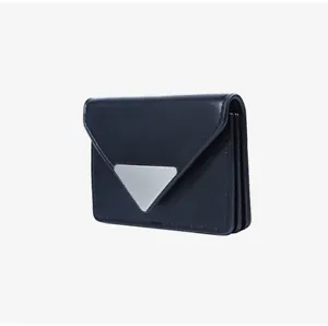 Detail of a black leather card holder featuring a silver triangle logo and gusseted pockets