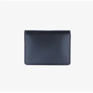 Detail of minimalist black leather card wallet with refined stitching and matte texture