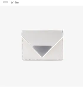 Macro view of white leather card wallet featuring V-flap and triangular metal detail
