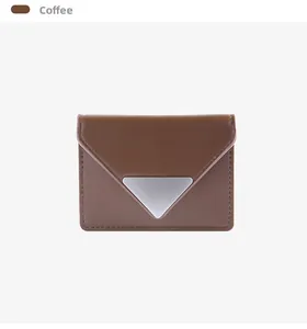 Close-up of coffee brown envelope card holder with iconic silver triangle metal buckle