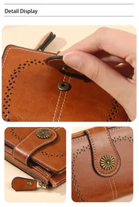 Detail display of brown vintage leather wallet with sunflower snap and wave stitching