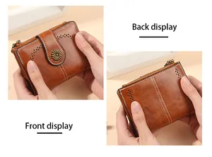 Macro view of brown vintage leather wallet with sunflower clasp and stitched details