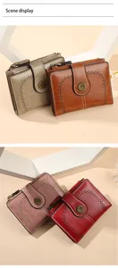 Detail of vintage oil wax leather wallets with sunflower buckles and hollow edges