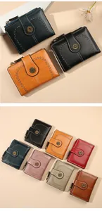 Detail of vintage oil wax leather wallets with sunflower buckle and contrast stitching
