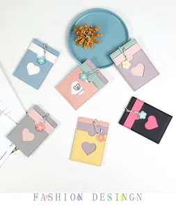 Close-up of colorful PU leather card holders with heart window and floral bead chains