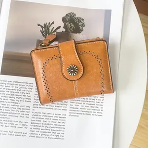 Detail view of retro brown faux leather wallet with metallic sunflower and hollow pattern