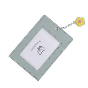Detail of light green PU leather card holder with clear window and flower pendant charm