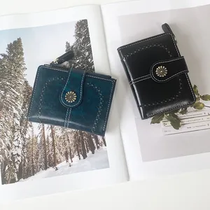 Vintage oil leather women's short wallets with daisy buckle and hollow design