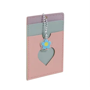 Detail view of macaron PU leather card holder with heart window and flower pendant