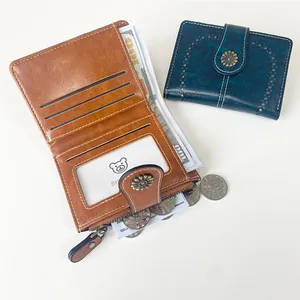 Vintage leather short wallet for women featuring a zip coin pocket and daisy rivet buckle