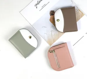 Macro shot of colorful pebbled leather wallets showing snap buttons and zipper coin pockets