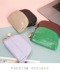 Close-up of shell-shaped mini coin purses in five colors with stone texture leather