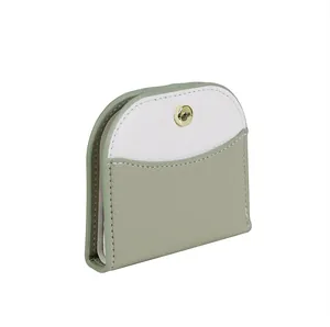 Detail view of the bicolor lychee grain leather wallet with a golden snap button