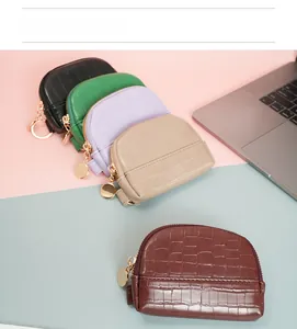 Detailed view of crocodile pattern mini shell coin purses in various colors with metal zippers