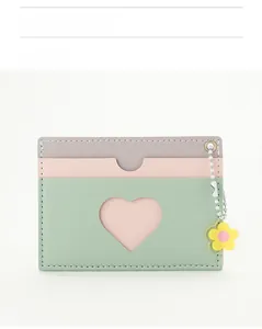 Detail of multi-color card holder featuring heart cutout and sunflower charm
