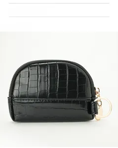 Close-up of black crocodile pattern coin purse with gold zipper and keyring detail