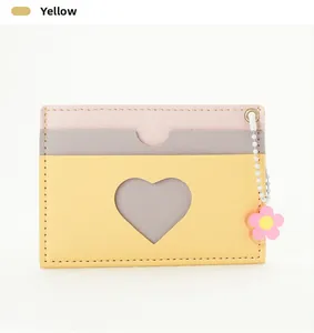 Detail of multi-color card wallet with heart cutout, yellow leather and flower charm