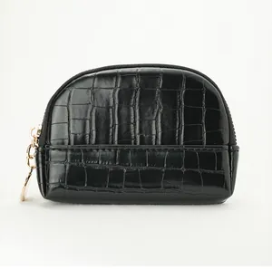 Detail of black stone pattern mini shell coin purse with gold zipper and textured finish