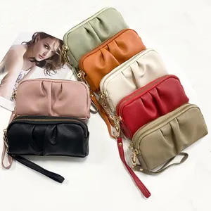 Close-up of pleated texture on multi-color leather wristlet bags with zipper details