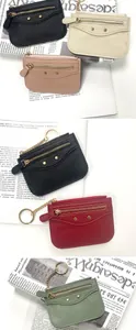 Litchi pattern leather coin purse with golden key ring and stud details