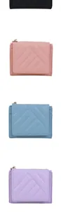 Detailed close-up of colorful quilted small wallets showing stitching and card slots