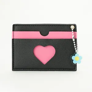 Chic leather card holder with heart cutout, contrast pink interior and floral keychain