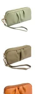 Close-up of pleated wristlet clutch bags in mint green, khaki and orange with dual zippers