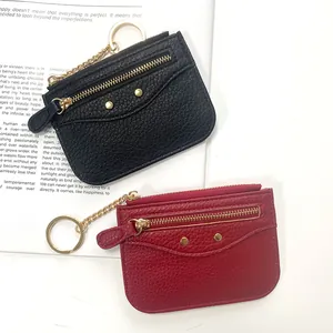 Litchi grain leather mini wallets in black and burgundy with gold hardware and keychains