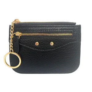 Black lychee leather wallet with gold zipper and integrated keychain ring on white background