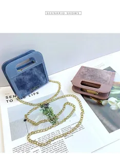 Detail of denim and velvet small crossbody bags with chain straps and gold lettering