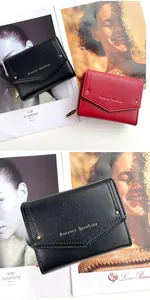 Close-up of black and red cross-grain leather wallets with gold Forever Sunshine lettering