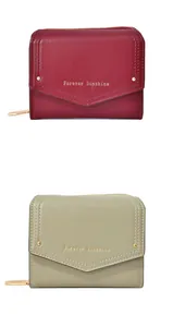 Detail view of burgundy and olive green wallets with envelope flaps and gold hardware