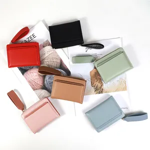 Close-up of stylish solid color leather card wallets with wrist straps in six pastel colors