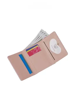 Internal view of pink tri-fold wallet showing multiple card slots and heart-shaped window