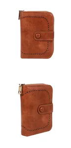 Dettaglio portafoglio vintage in pelle marrone con intagli e cerniera a forma di U