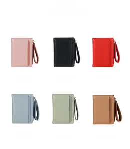 Detailed view of Saffiano leather wallets in six colors with zippers and wrist straps
