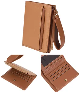 Detailed view of brown lychee grain leather wallet with wrist strap and card slots