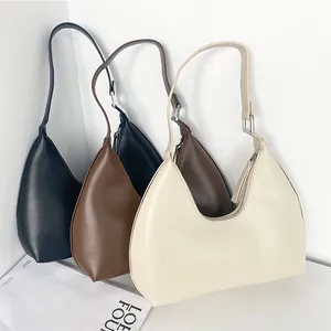 Three minimalist PU leather crescent underarm bags in black, brown and off-white