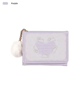 Close-up of lavender purple tri-fold wallet featuring cute white bunnies and plush ball charm