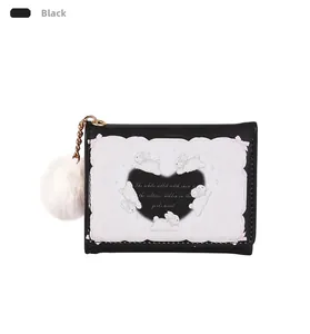 Close-up of black PU leather bifold wallet with rabbit print and white pom-pom charm