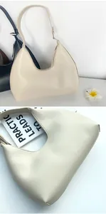 Detail view of smooth PU leather minimalist crescent underarm bag with zipper closure