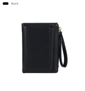 Close-up of black crossbody wallet featuring fine cross-grain texture and wrist strap