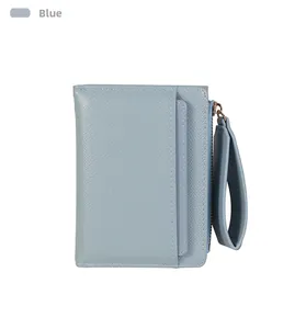 Detail view of light blue leather wallet featuring a side zipper and wide wristlet strap