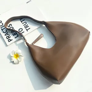 Minimalist dark brown half-moon hobo bag in matte leather for women with shoulder strap