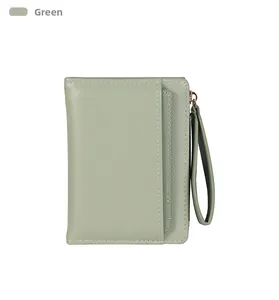Detail of green litchi texture short wallet featuring a zipper and matching wrist strap