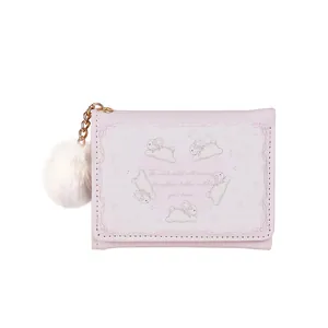Cute pink trifold wallet with white rabbit patterns and a soft fur ball keychain