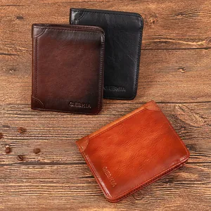 Vintage genuine leather men's wallets in brown and black on a rustic wooden table